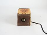 a small wooden box with a wire attached to it