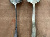 two spoons sitting next to each other on a table