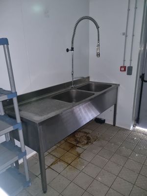 une cuisine équipée d'un évier et d'une échelle