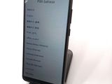 a phone that is sitting on a stand on a table