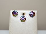 une paire de boucles d'oreilles multicolores et un collier posés sur un présentoir blanc