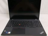 the laptop is open on a white surface with a black keyboard