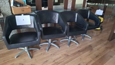 four chairs that are sitting in a row on the floor