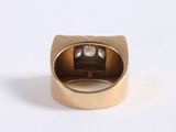 a close up of a gold ring with a diamond in it
