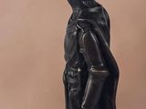 statue of a man with a bird on his head on a pedestal