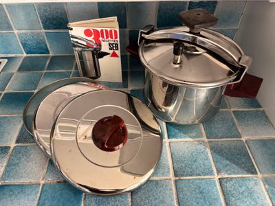 pots and pans sitting on a blue tiled counter in a kitchen