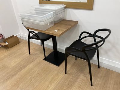 two chairs and a table in a room with a mirror