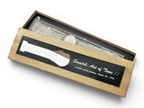 a box with a knife and fork inside of it on a white surface