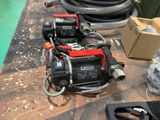 two air compressors sitting on a table next to a hose