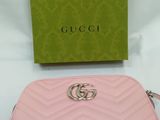 a pink gucci wallet with a green box on the side