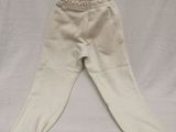 cream colored baby pants on a white background with a white background
