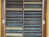 a wooden cabinet with a bunch of papers in it