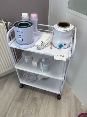 a small cart with a pot on top of it next to a radiator