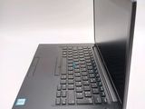 a laptop computer sitting on a table with a keyboard