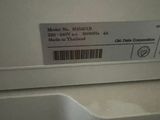 a label on the side of a washer in a bathroom
