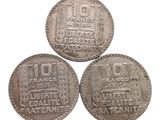 three silver coins with the names of different countries on them