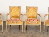 four chairs with a yellow upholstered back and a red and gold upholstered back