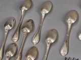a lot of silver spoons and forks on the table