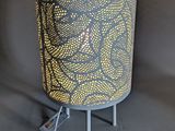 a close up of a lamp on a stand with a cord