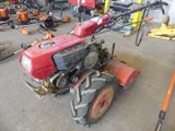 a red tractor that is parked in a garage