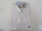 a white dress shirt wrapped in plastic on a table