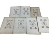 six old books with drawings of flowers and birds on them