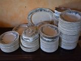 a lot of plates and bowls on a table