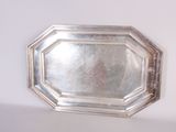 a silver tray with a mirror on top of it