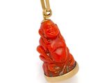 a close up of a red buddha charm on a white background