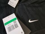 a close up of a black jacket with a price tag on it