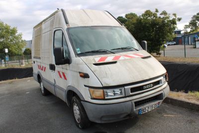 a white van that is parked on the side of the road