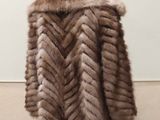 a close up of a fur coat on a mannequin stand