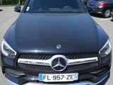 the mercedes gle is parked in a parking lot with other cars in the background