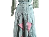 green and pink dress on a mannequin stand on a white background