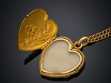 a close up of a heart shaped locke on a chain