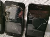 three cell phones with broken screen sitting next to each other on a carpet