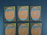 four decks of magic the gathering card game on a table
