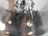 a silver plate with a design on it on a table