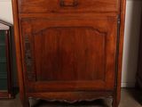 a wooden cabinet with a mirror on top of it