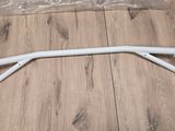 a close up of a pair of white metal bars on a wooden floor