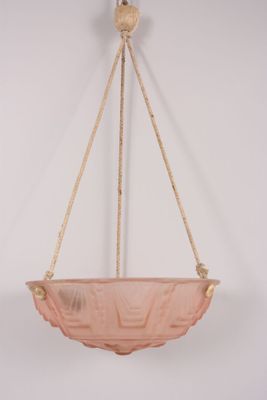 an image of a pink glass hanging bowl on a rope