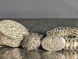 a lot of silver objects that are on a table