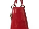 a red handbag with a metal handle on a white background