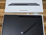 an open box of a tablet computer sitting on top of a wooden table