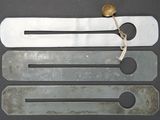 four spoons and a spoon rest on a table