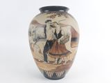 a vase with a picture of a man and a woman on horseback