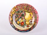 a plate with a painting of a vase and fruit on it