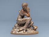 bronze statue of a woman sitting on a rock with her hand on her chin