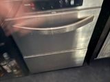 a silver dishwasher in the middle of a kitchen