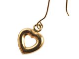 a close up of a pair of gold heart earrings on a white background